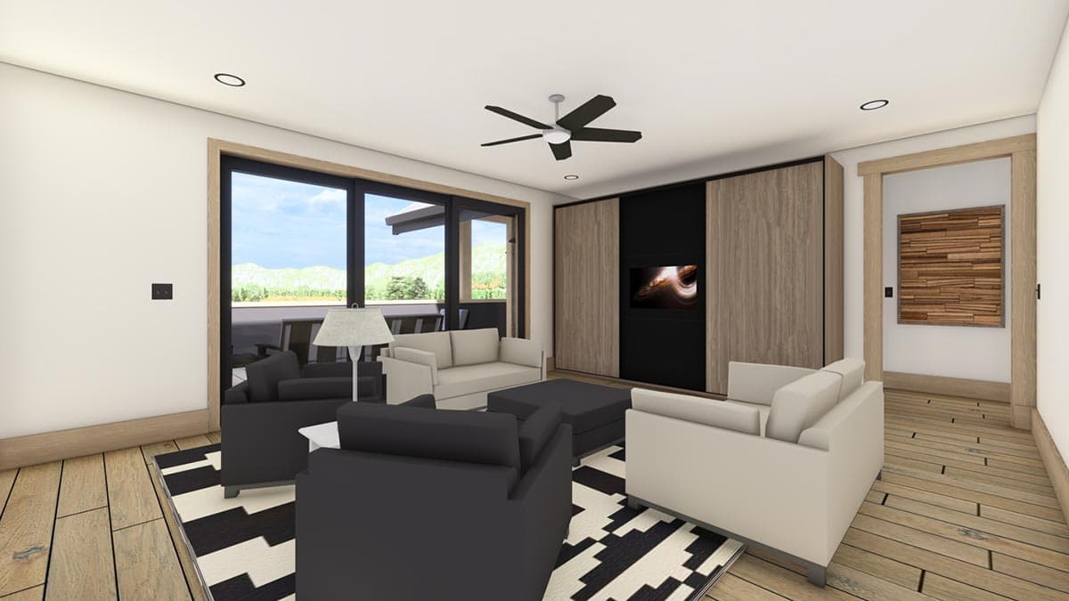 Modern living room with black and white rug, comfortable seating, and a TV recessed into a wood-paneled wall, open to a deck.
