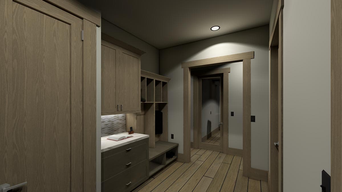 A hallway with light wood flooring and trim.  A built-in bench and cabinets line the wall opposite multiple doorways.