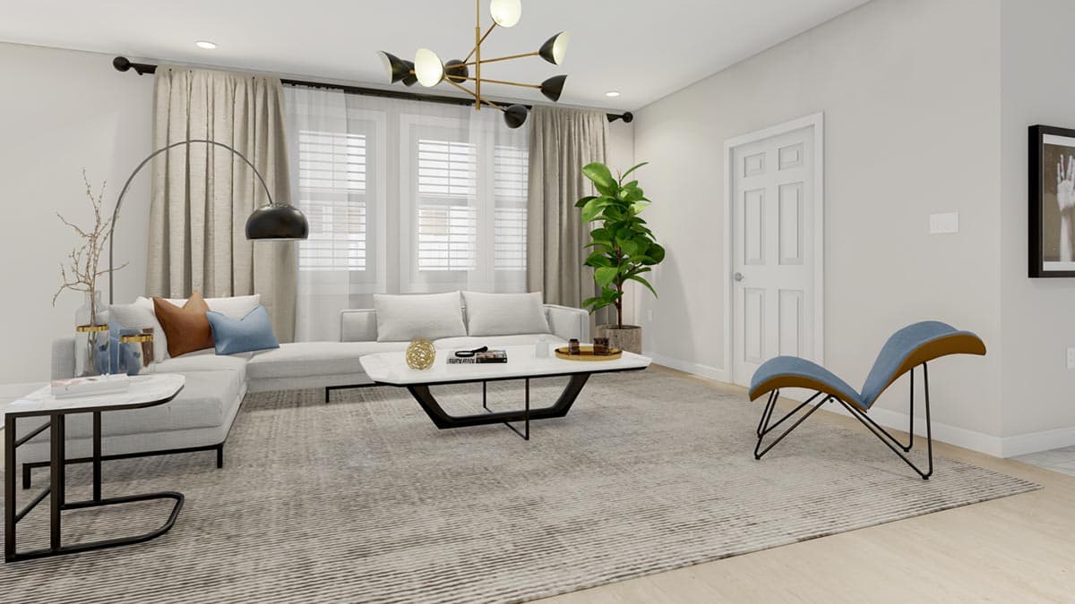 Living room with sectional sofa, modern chandelier, abstract chair, and large area rug.