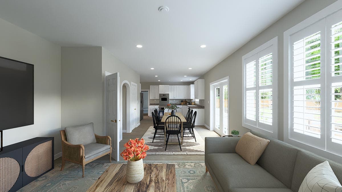 Open-concept living and dining areas flow into a kitchen with white cabinets and a long island. Features include plantation shutters.