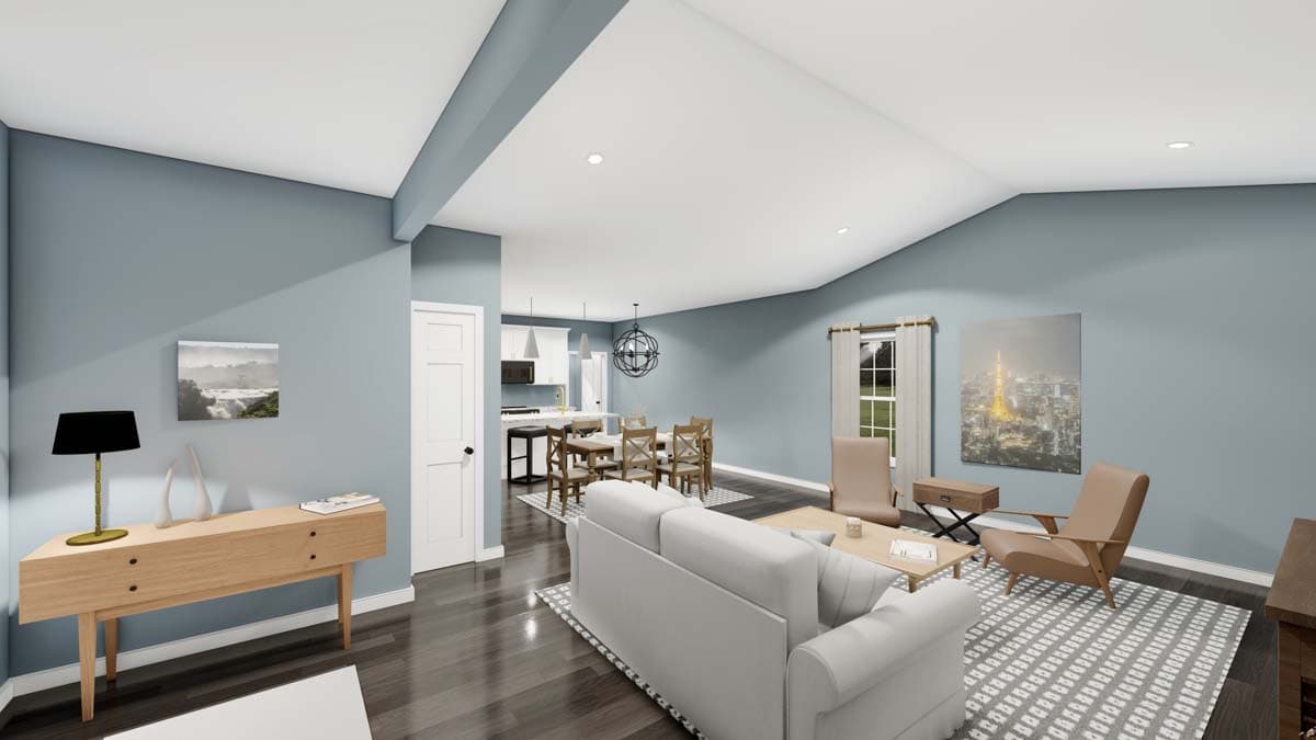 Open concept living area with vaulted ceiling, dining room, and kitchen with island. Modern furniture and decor visible.
