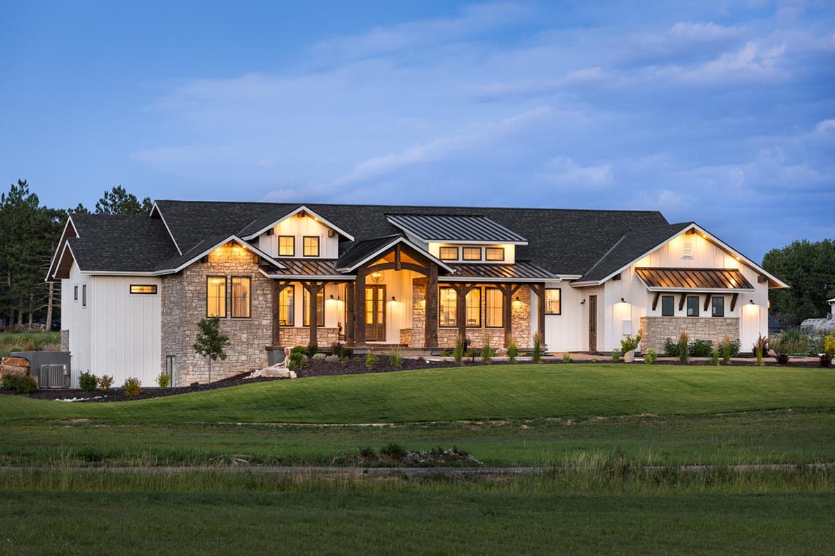 Modern Farmhouse house plan exterior with stone accents, multi-gabled rooflines, and a large covered entry porch.