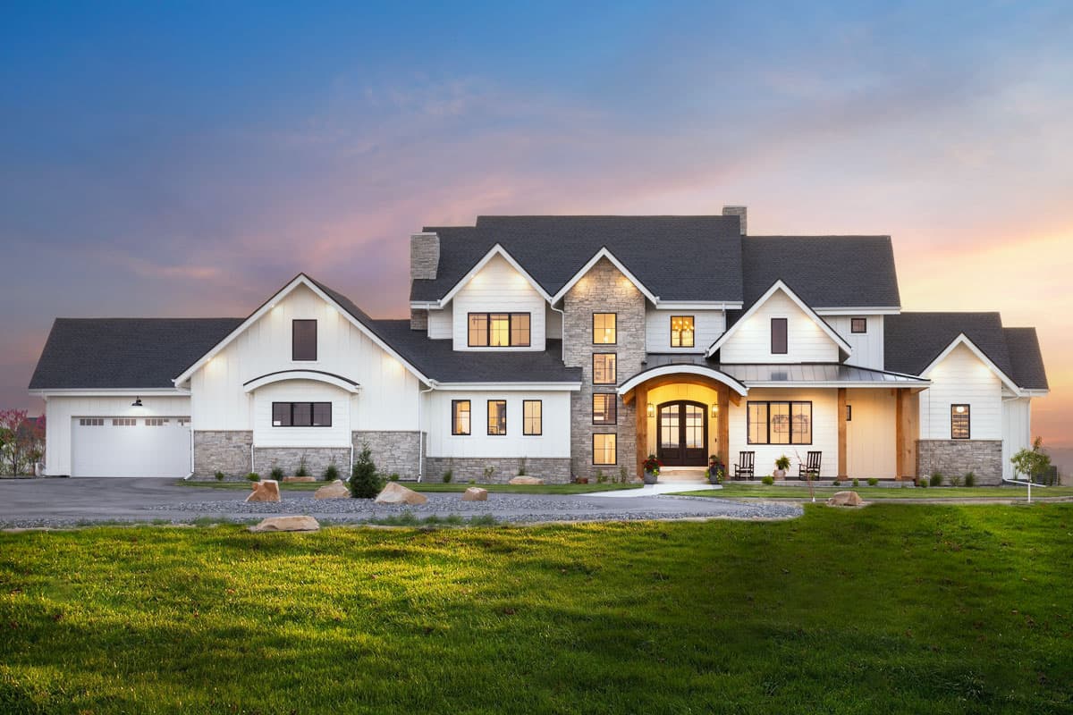 House plan exterior. Two-story Modern Farmhouse with gabled rooflines, stone accents, and a covered entry porch over front door.