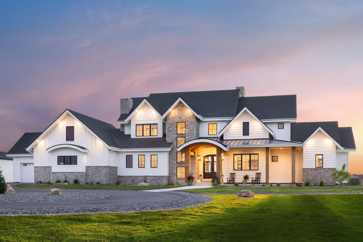 Modern Farmhouse house plan exterior with multiple gables, stone accents, arched entry, and attached garage.