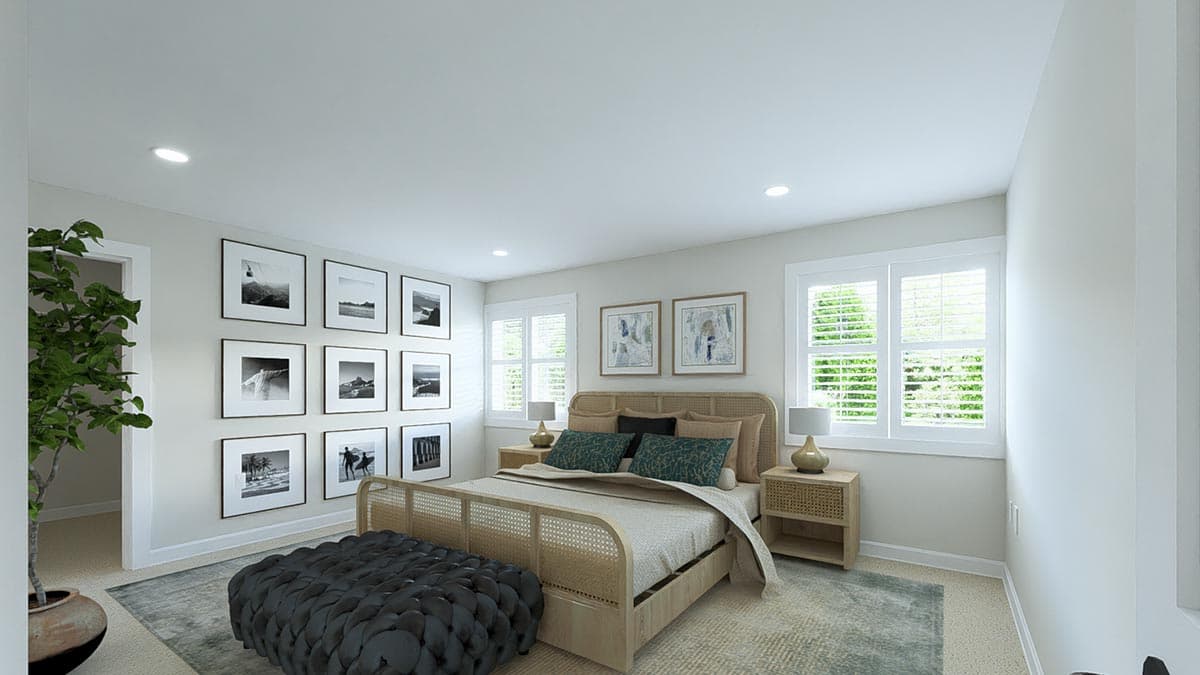 Primary bedroom with king bed, woven headboard, wall gallery of black and white photos, and plantation shutters on windows.