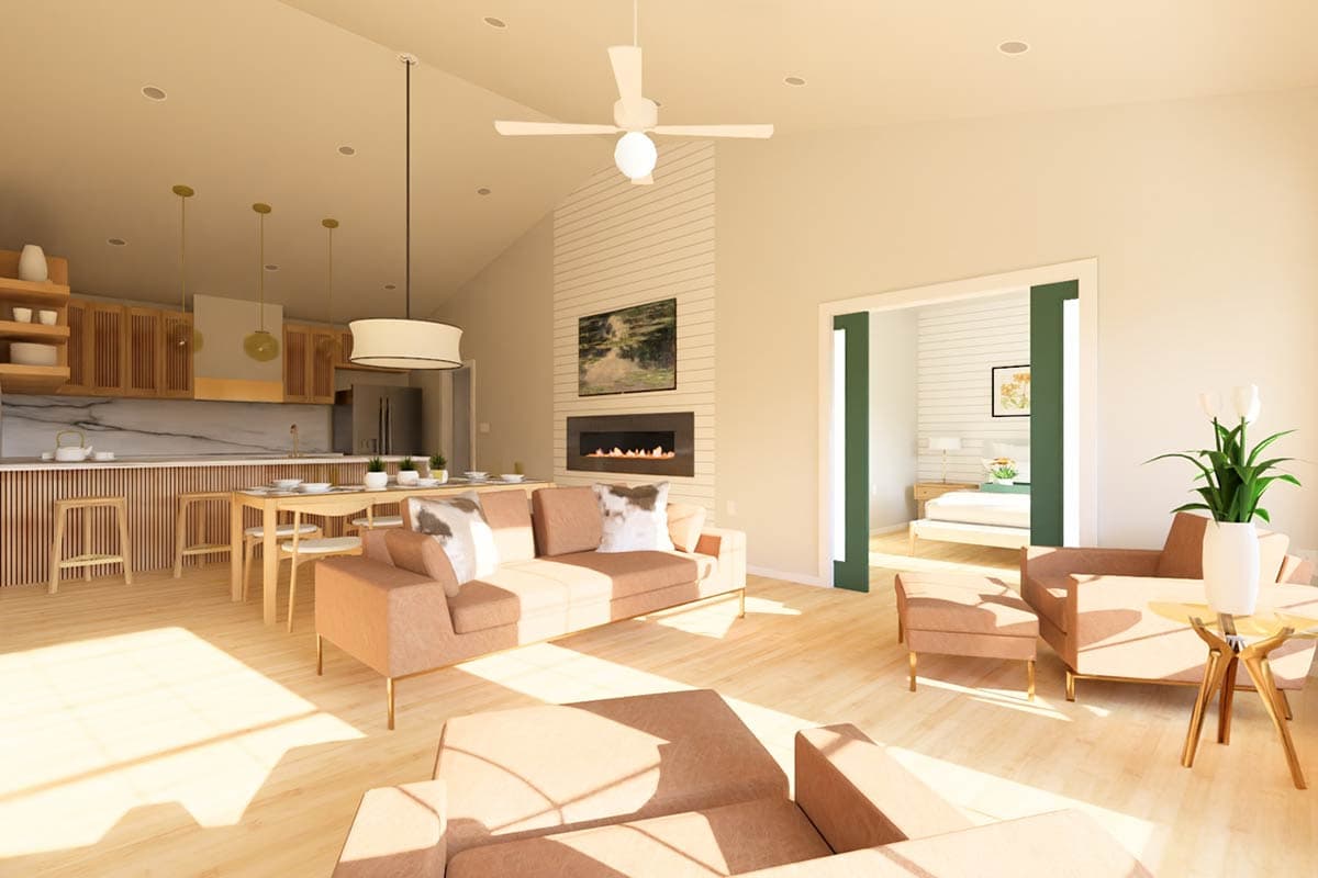 Modern open-concept living space with kitchen, dining area, fireplace, and view into a bedroom.