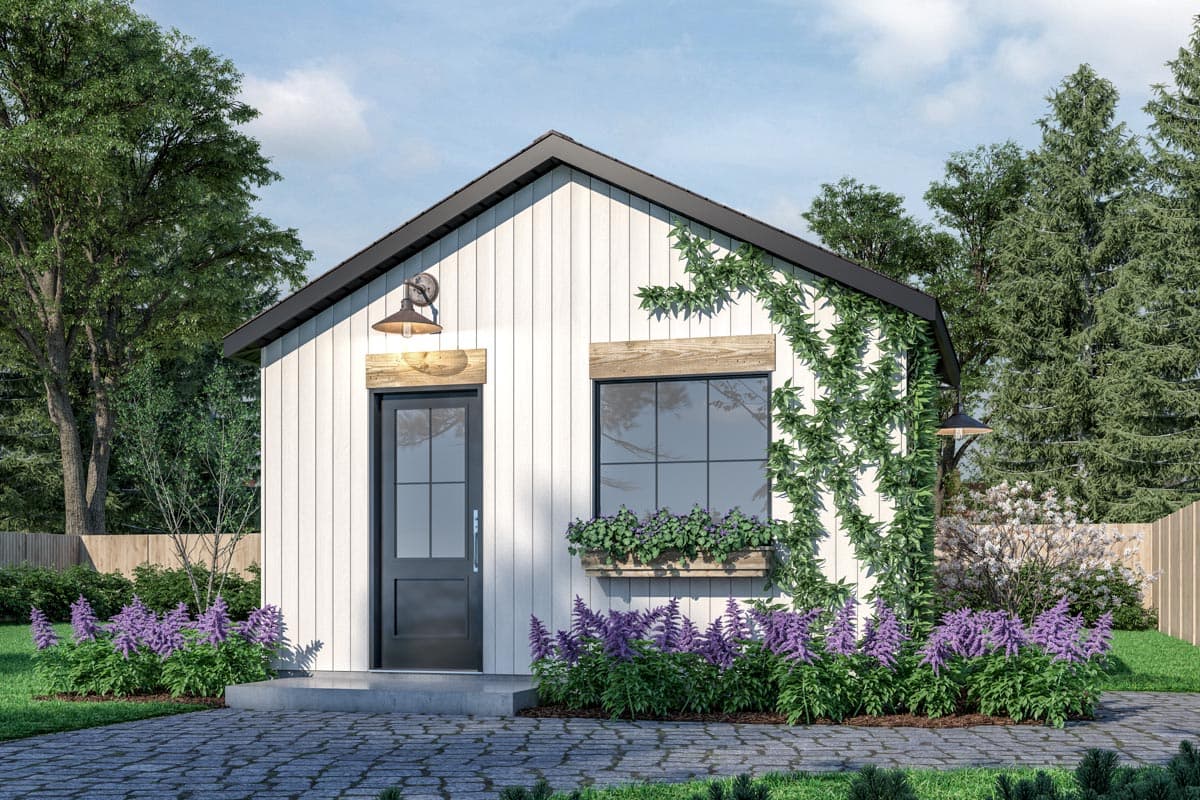 House plan exterior. One-story structure with board-and-batten siding, a gable roof, and a black door. Includes a window box and wall-mounted sconces.