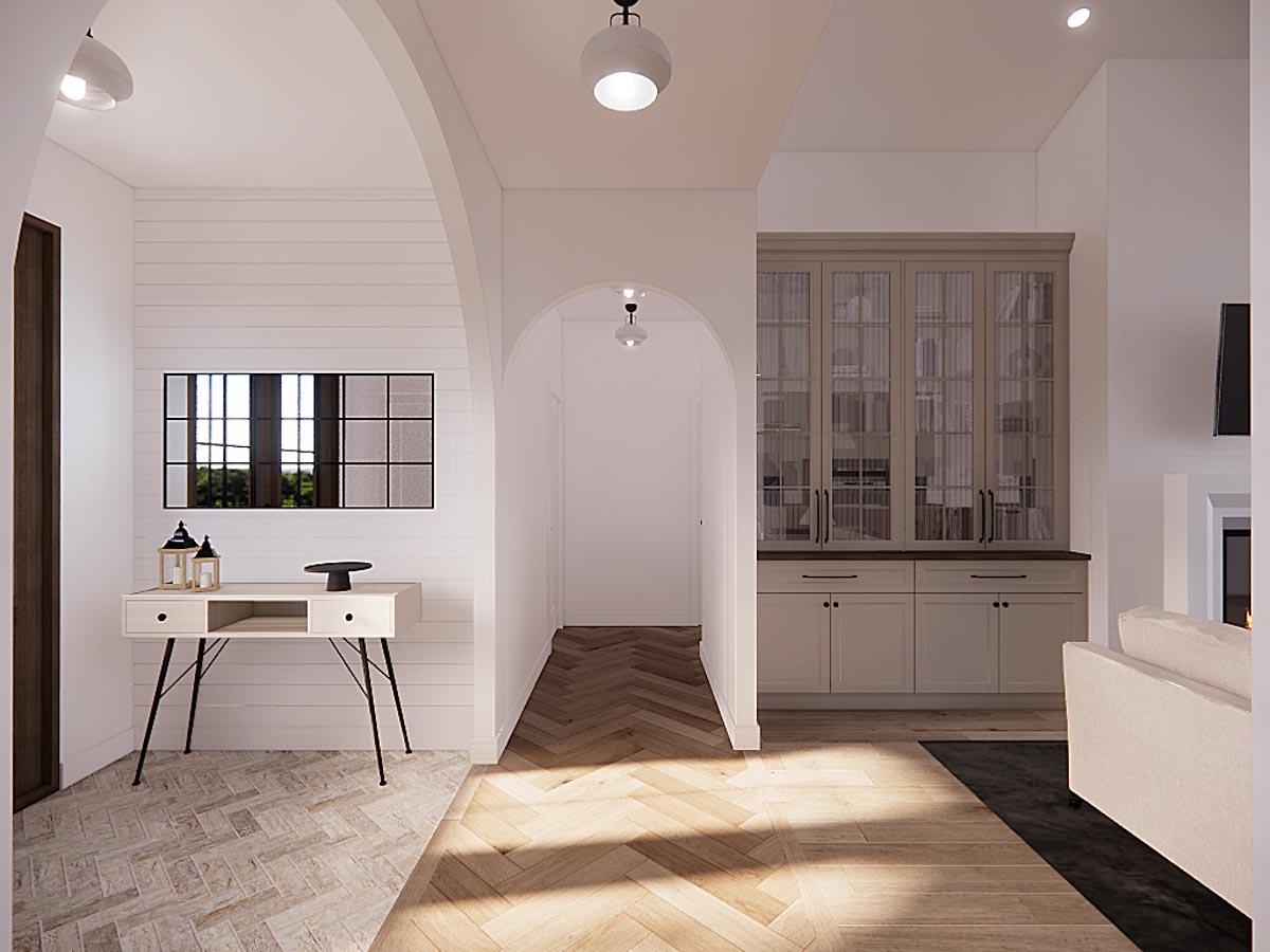 An interior hallway with a light-filled aesthetic. Features include an arched doorway, a decorative console, a wooden floor, and built-in cabinetry.