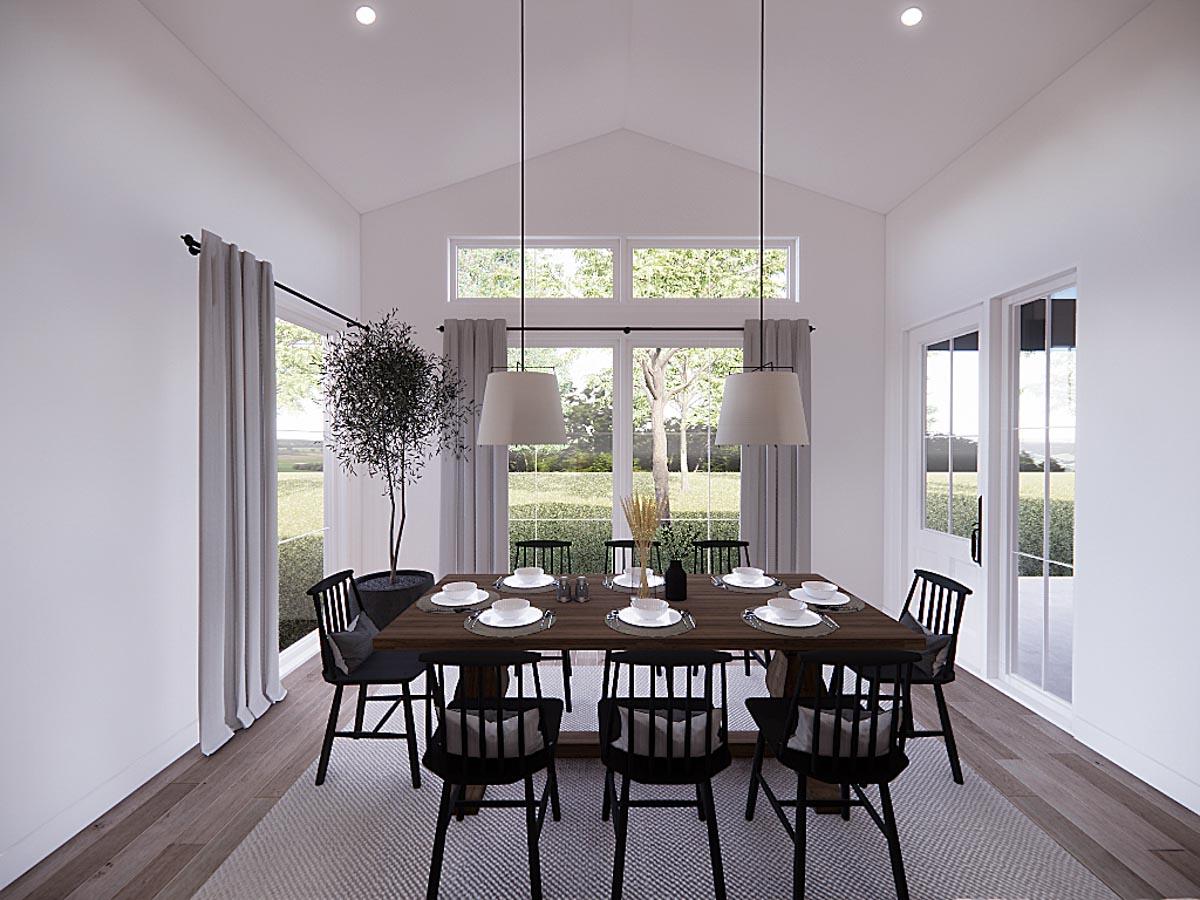 Dining room with a long wooden table set for a meal. Black chairs surround the table. Large windows provide a view of the outdoors.