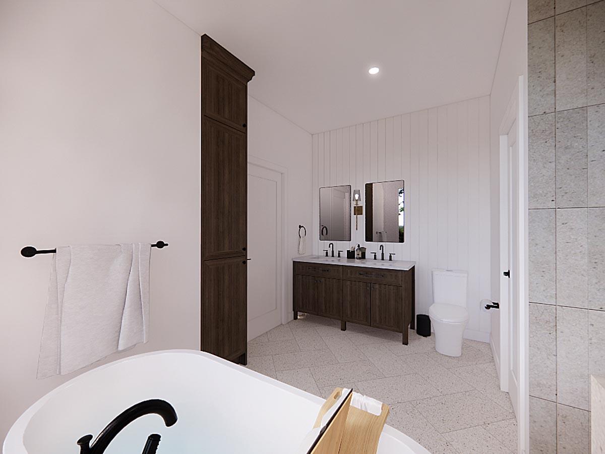 Modern bathroom featuring a soaking tub, dark wood vanity, and a tall storage cabinet. The space has bright white walls and a tiled floor.