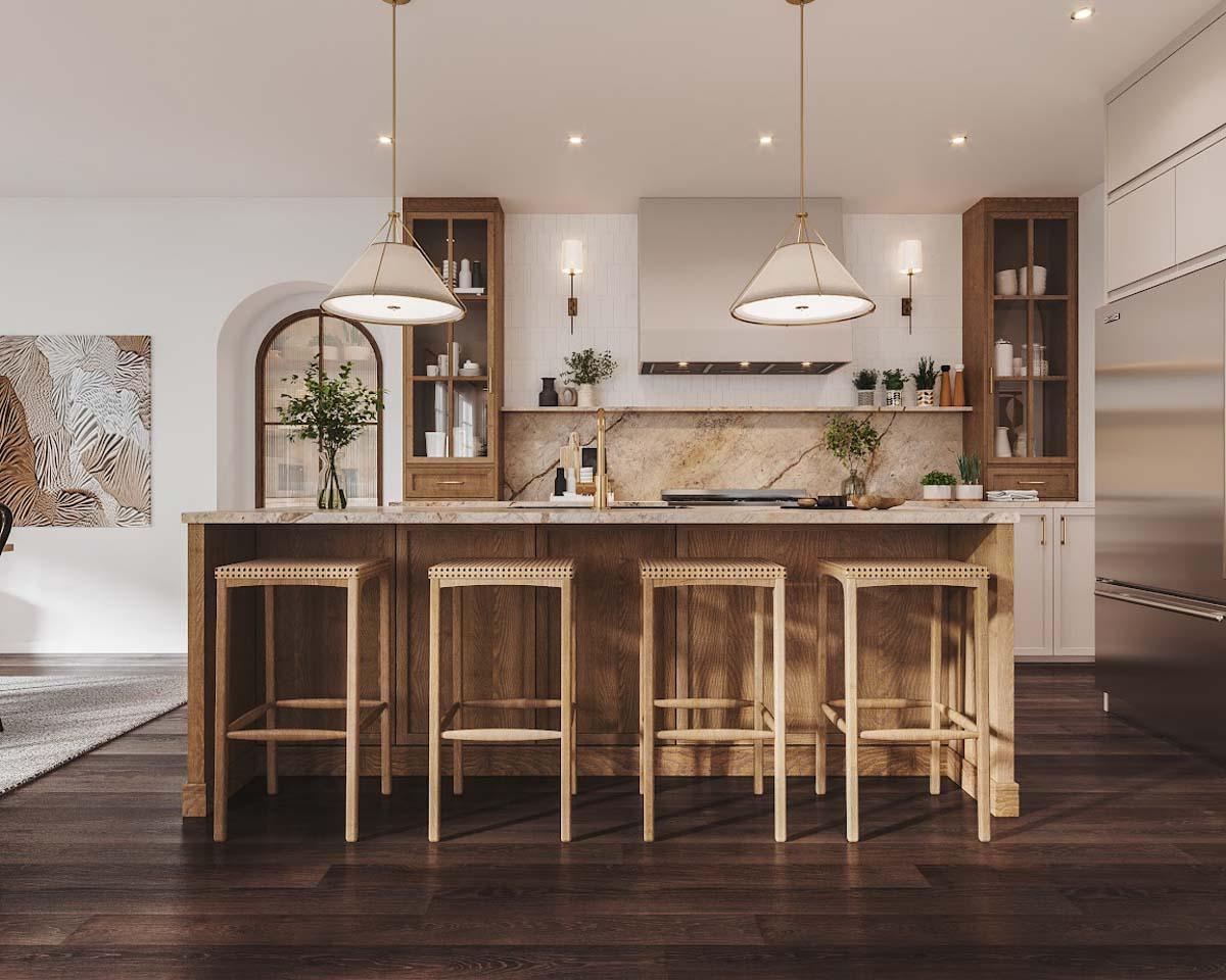 Modern kitchen with a large island with wooden bar stools. Overhead are two pendant lights. A stainless steel refrigerator stands in the corner.