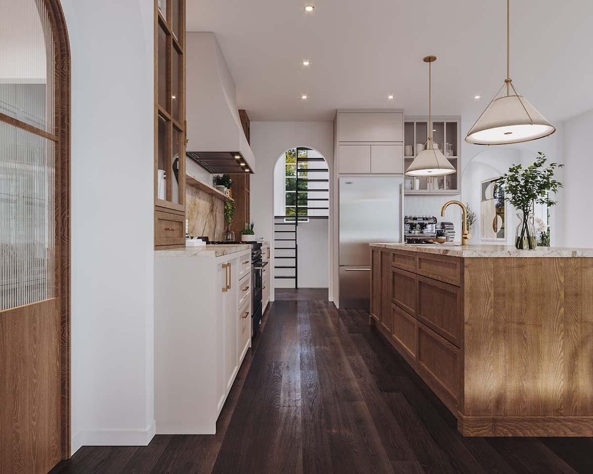 A modern kitchen with a large wooden island, marble countertops, and dark hardwood floors. Sunlight pours in from the arched doorway and window.