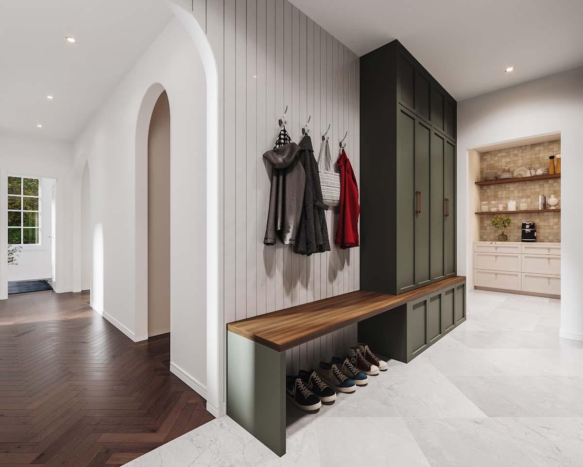 Modern entryway with dark wood bench, coat rack, and built-in storage. Hallway leads to a kitchen with tiled backsplash and white cabinets.