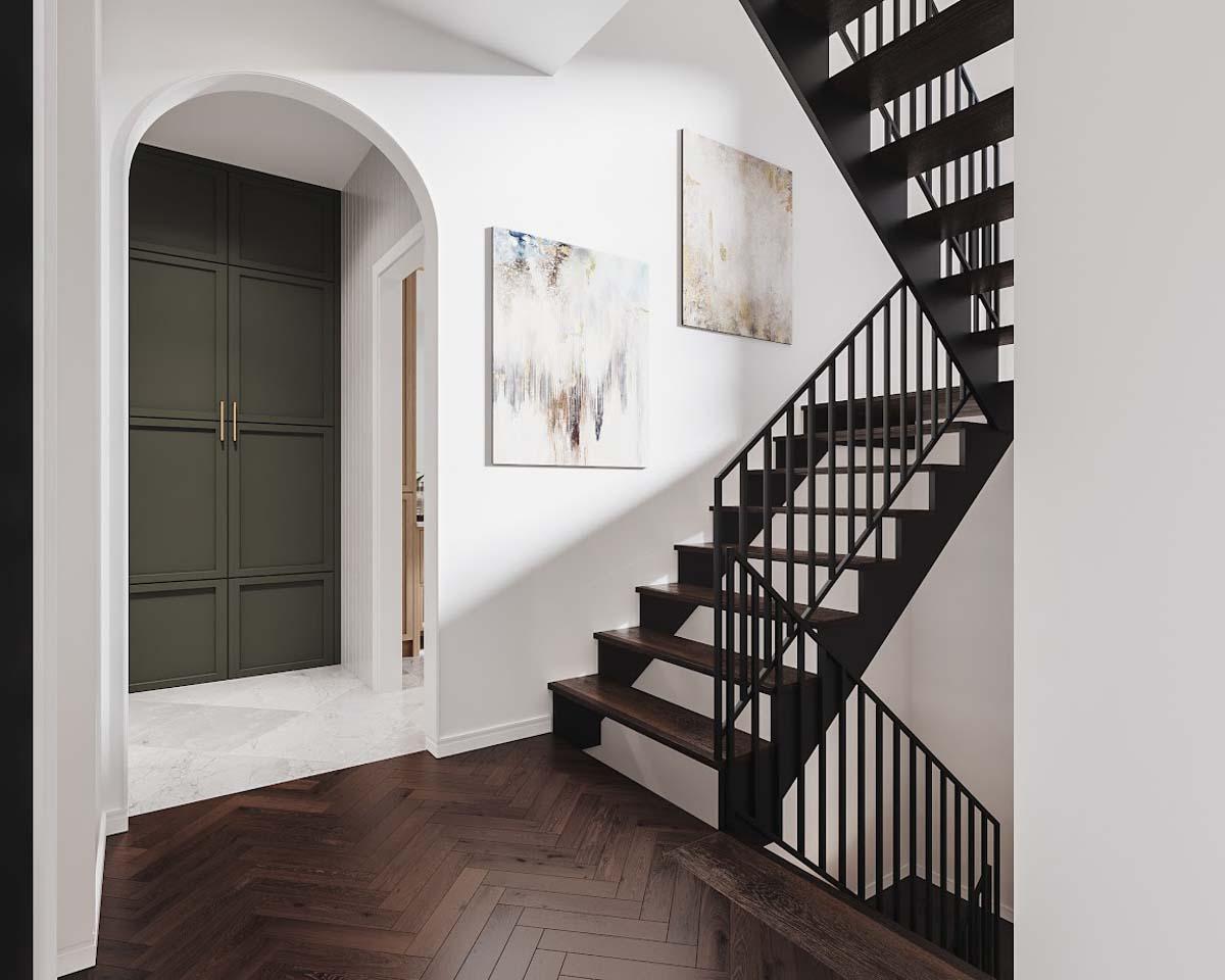 Interior shot featuring a dark wood staircase with black railings, abstract artwork, and a hallway leading to a green cabinet, dark wood floors.