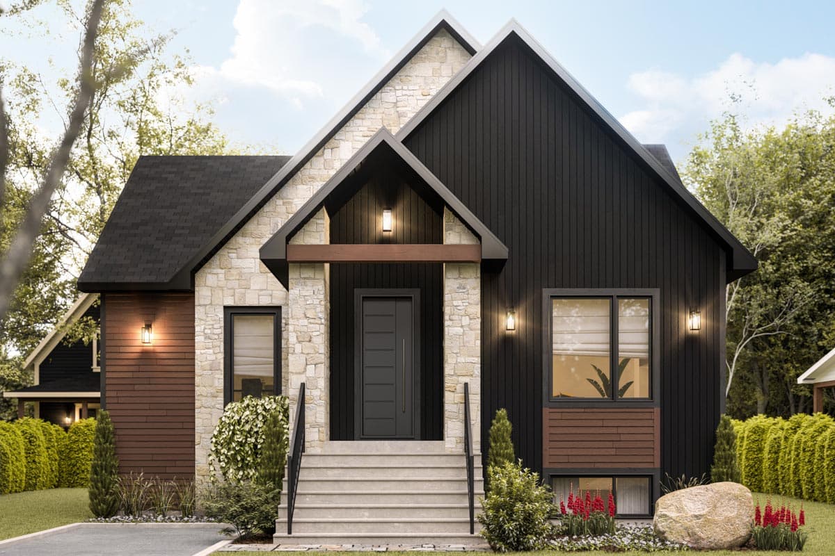 A modern house with a combination of dark siding and stone facade. A front door leads to a set of stairs. Landscaping surrounds the house.