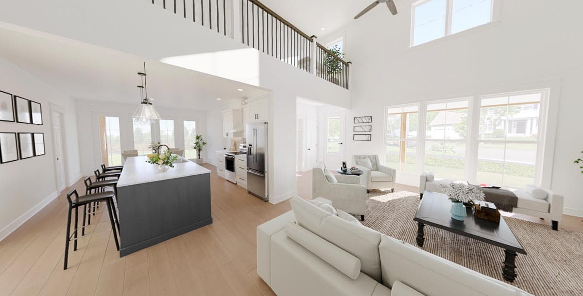 Open concept living area with vaulted ceiling, large windows, kitchen island with seating, and a loft overlooking the space.