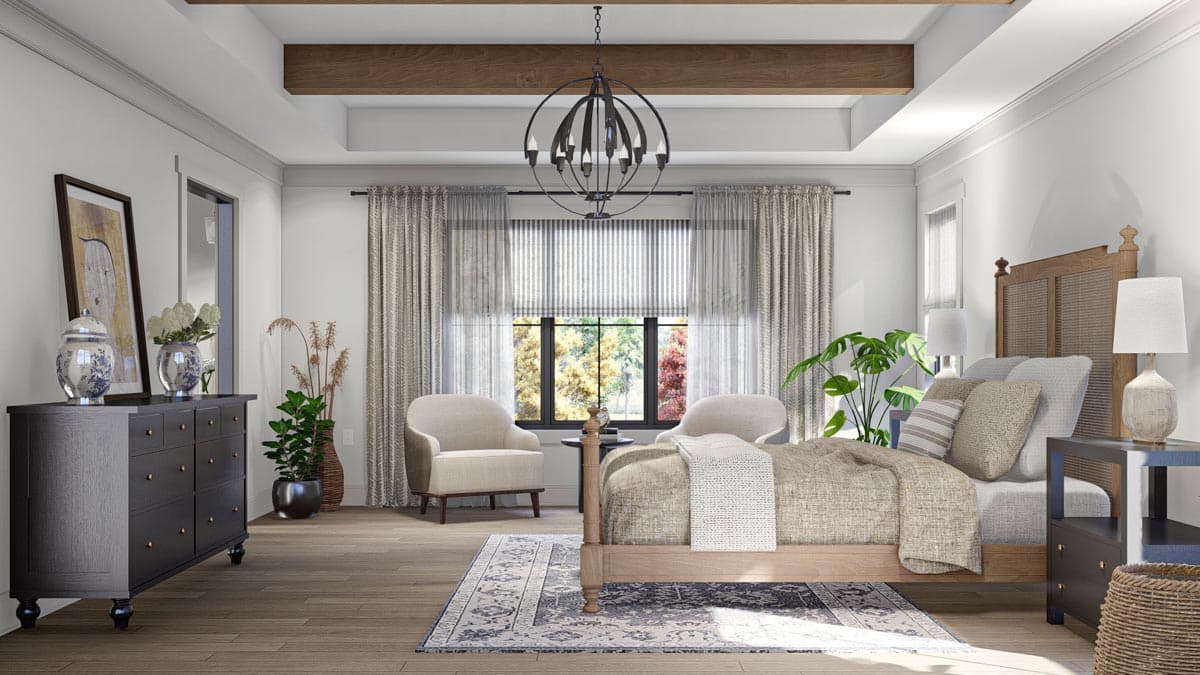 Primary bedroom with tray ceiling, wood beams, king bed, dresser, and seating area by large window.