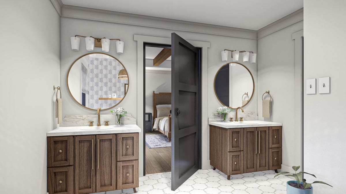 Dual vanity bathroom with wood cabinets, marble counters, round mirrors, and open doorway to bedroom with wood beams.