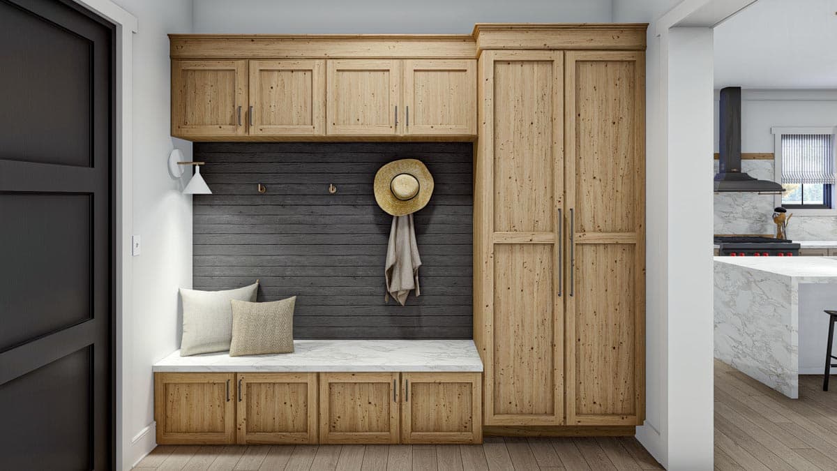 Entryway with wood cabinetry, built-in bench with marble top, and dark wood paneled wall.