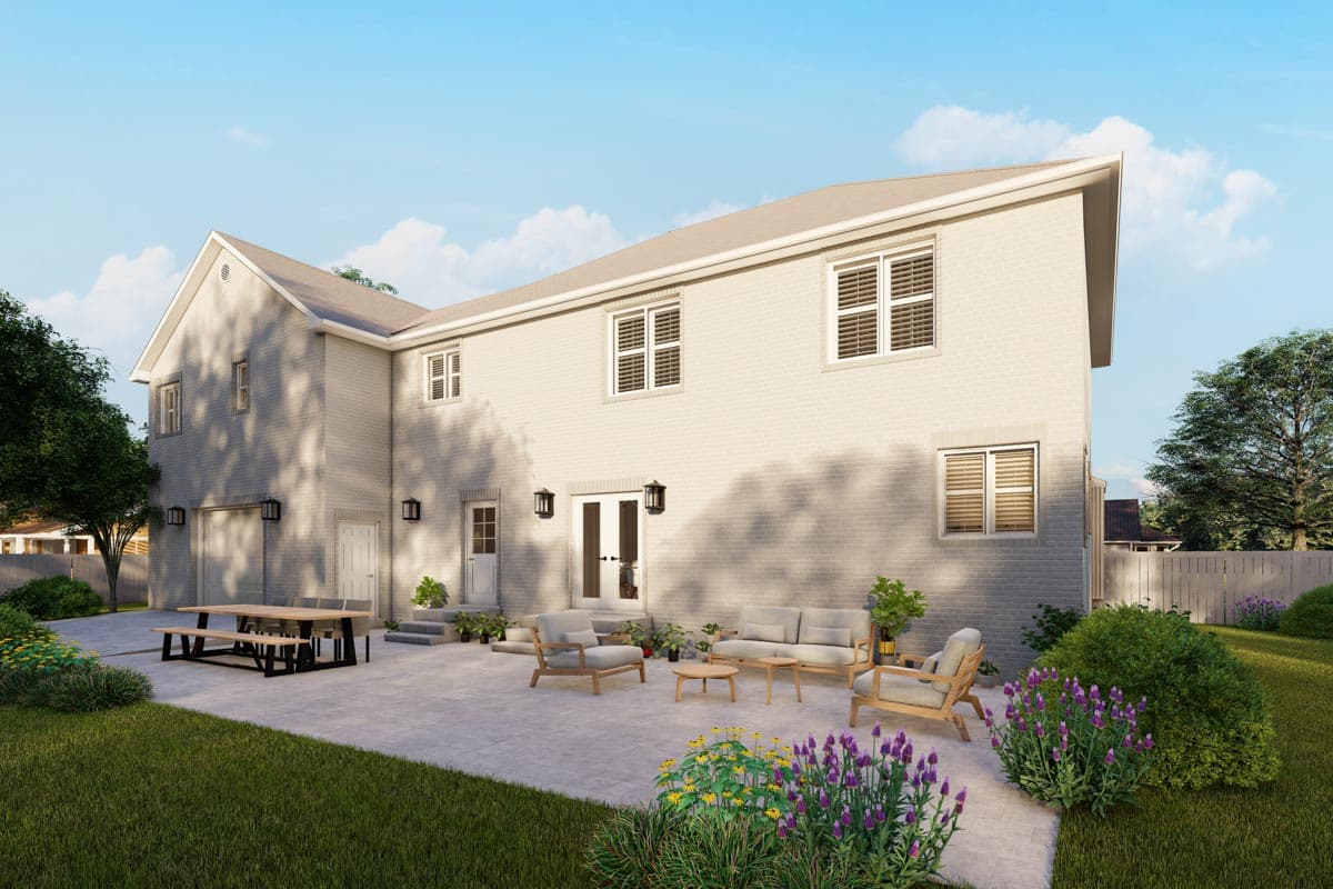Two-story house plan exterior with white brick, a gable roof, front-facing garage, and patio furniture.
