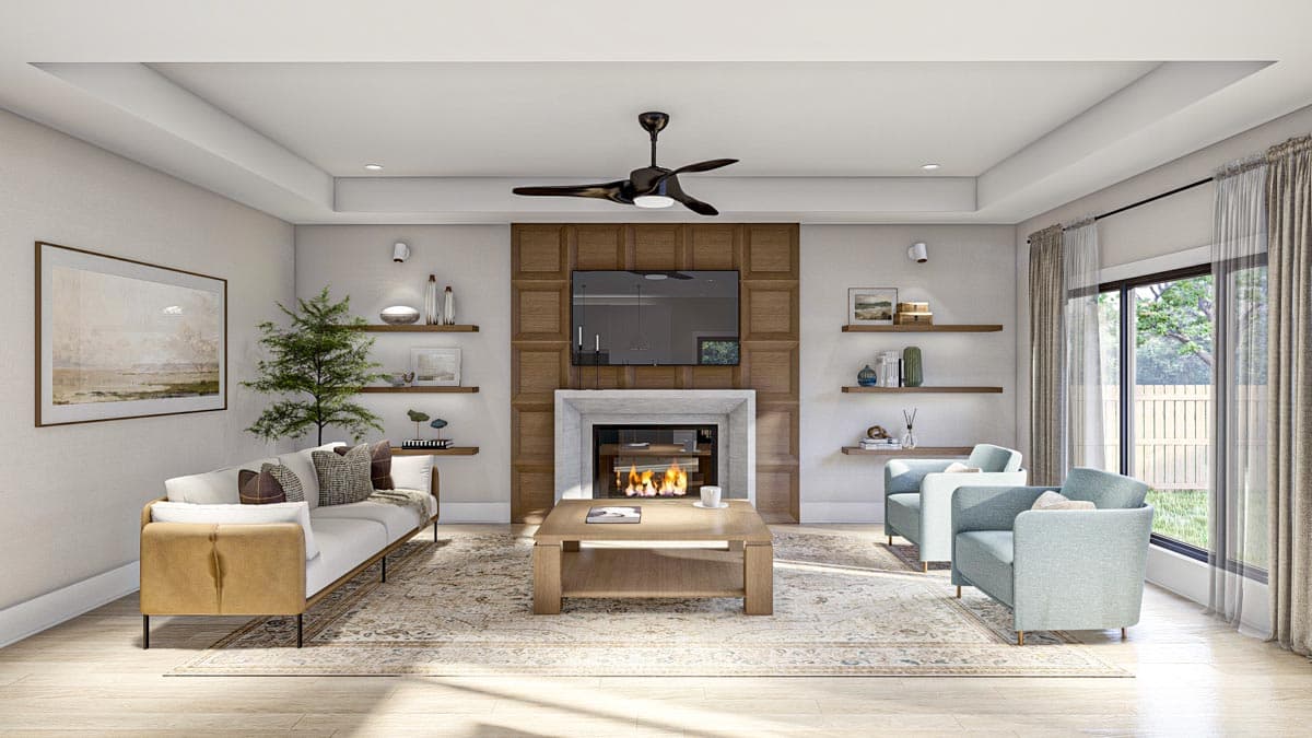 Living room with fireplace, wall-mounted TV, a sofa, two armchairs, and a large window with drapes.