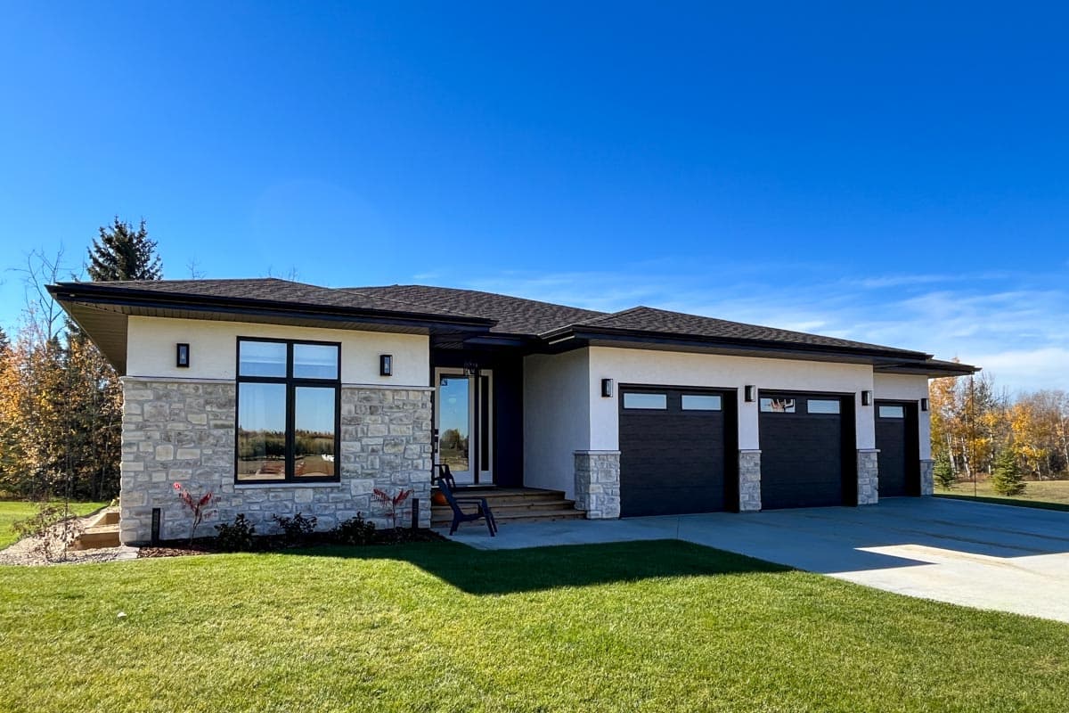One-story house plan exterior with stone accents, a prominent entryway, and a three-car garage.