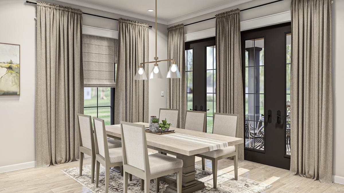 Dining room with light wood table, upholstered chairs, modern pendant light, double doors, and patterned curtains.