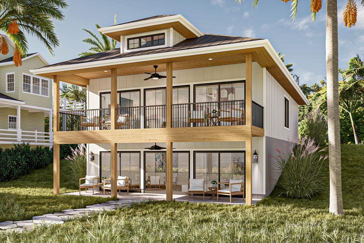 House plan exterior with two stories, wrap-around deck, gabled roof, and large windows. Elevated foundation.
