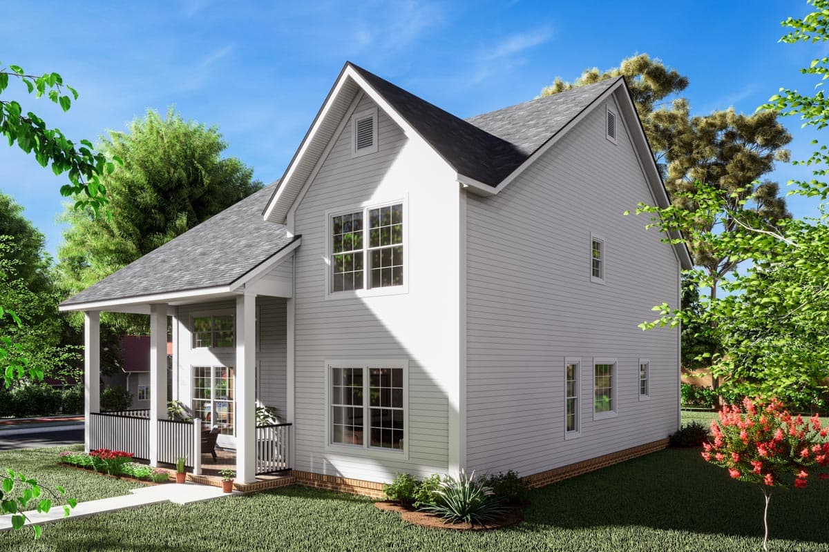 House plan exterior: Two-story dwelling with a gabled roof, front porch with railings, and multiple grid windows.