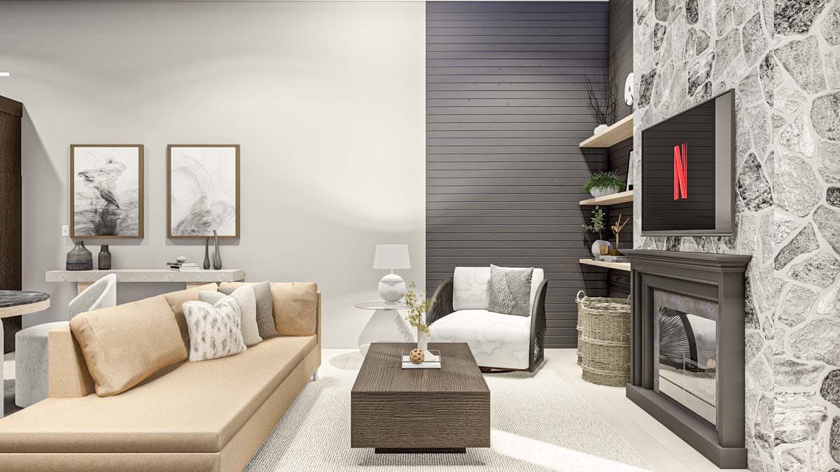 Living room with a tan sectional, armchair, fireplace, stacked stone accent wall, and wood-paneled wall.