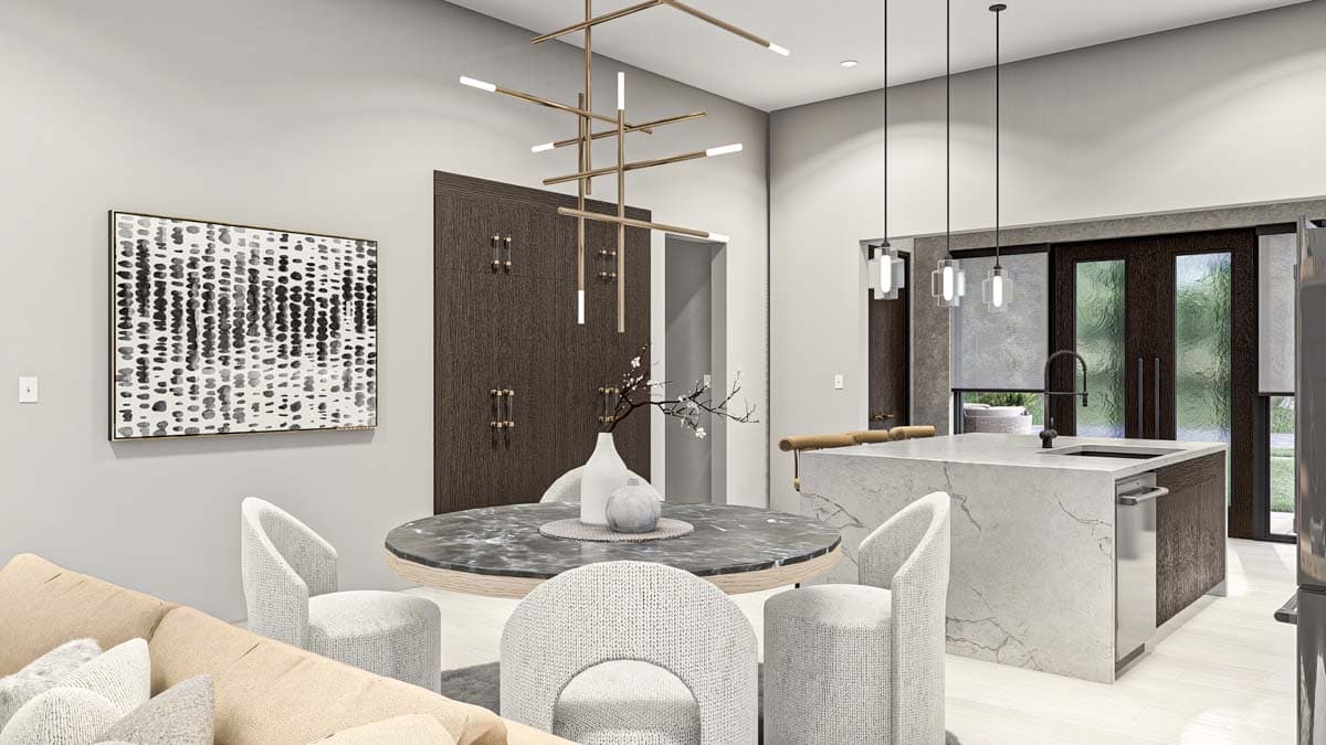 Modern dining and kitchen area with island, pendant lights, abstract art, and contemporary furniture.