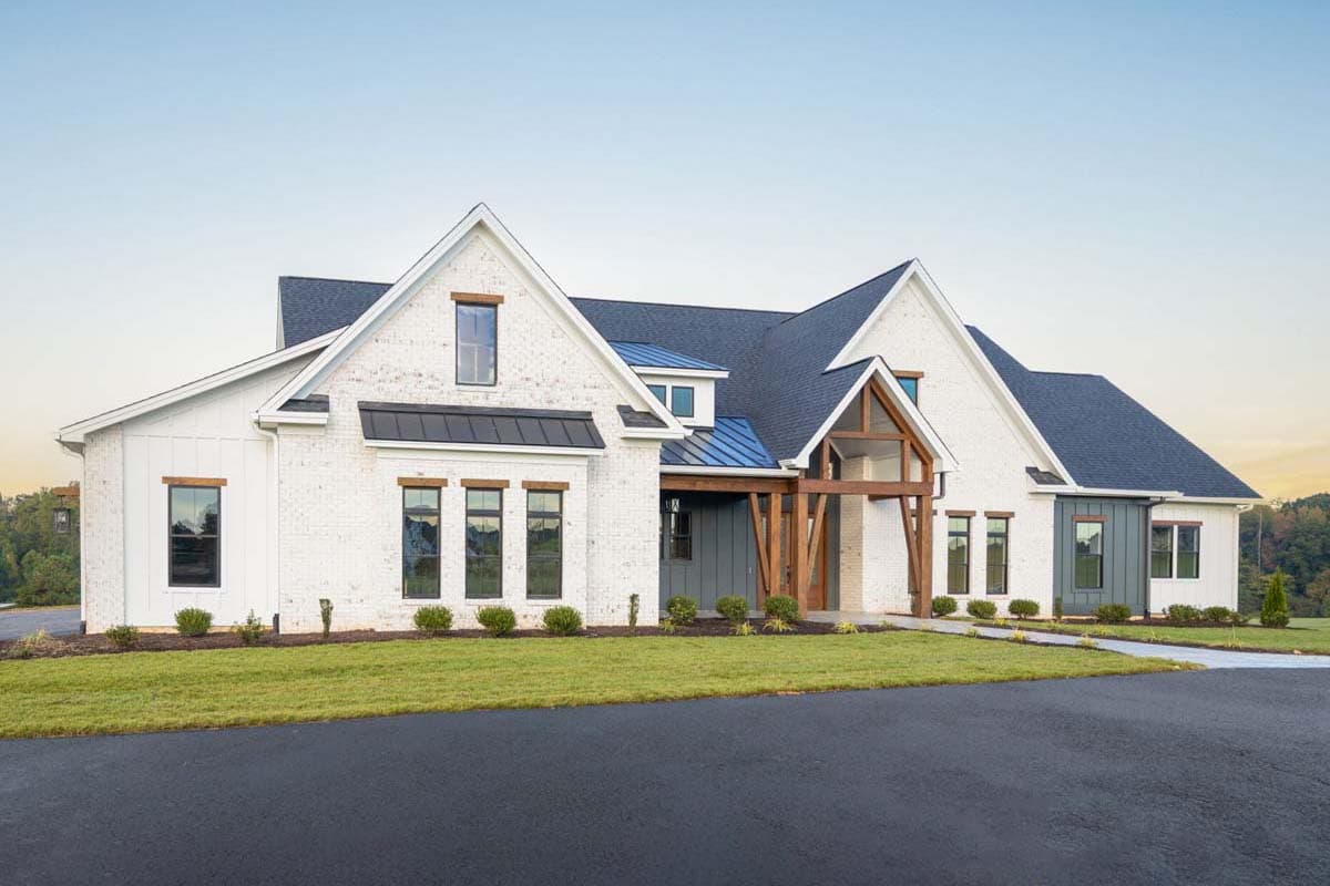 Modern Farmhouse house plan exterior with white brick, dark roof, gables, dormers, and timber accents.