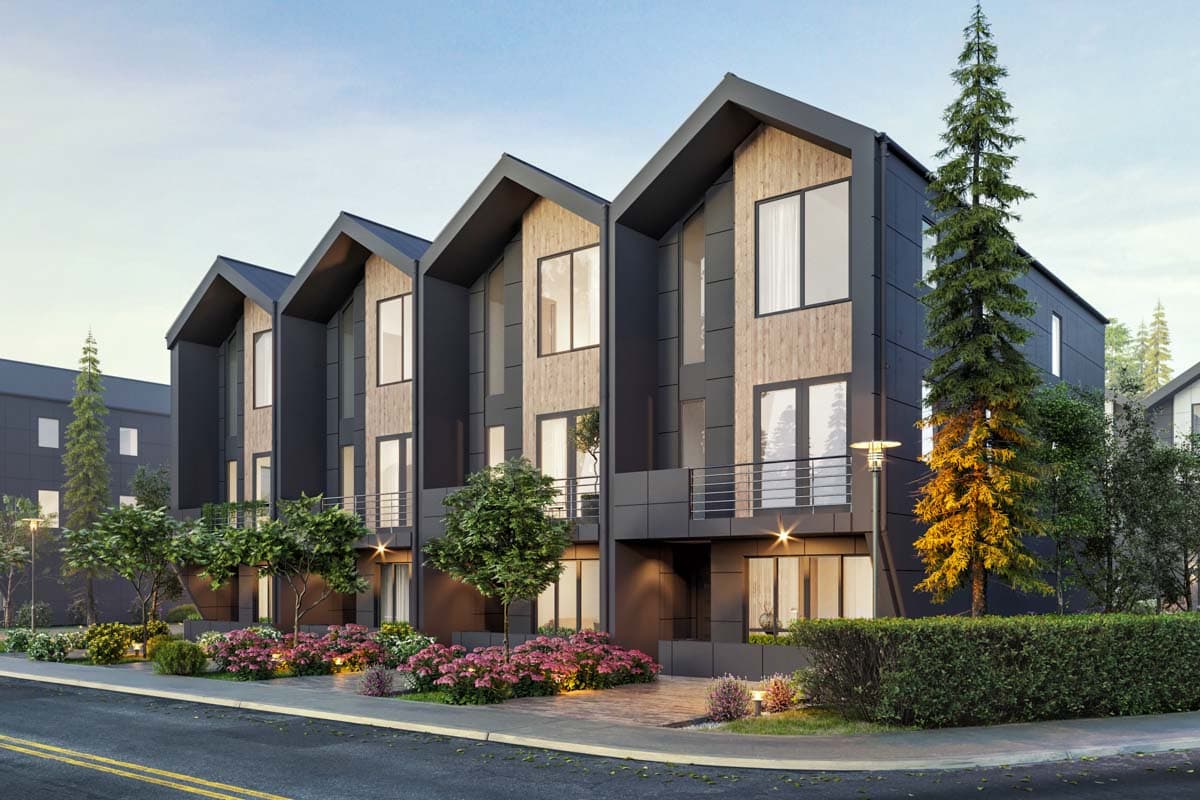 Modern townhouse exterior with dark siding, wood accents, large windows, balconies, and pitched rooflines.