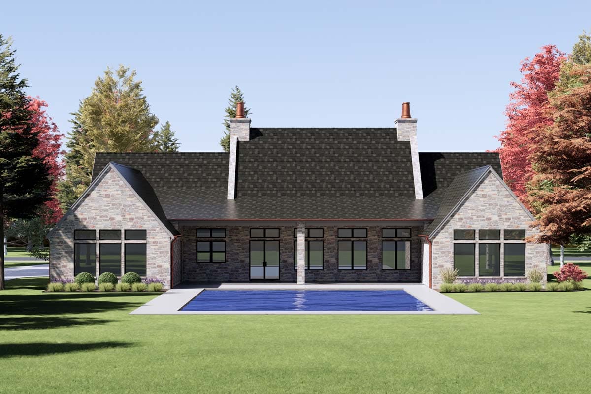 House plan exterior: one-story stone home with gabled roofs, two chimneys, and large windows flanking a central glass door.