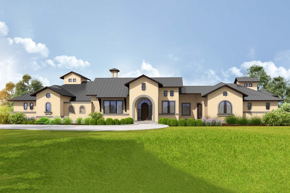 House plan exterior. One-story Mediterranean style with a dark metal roof, arched entryway, dormers, and a circular driveway.