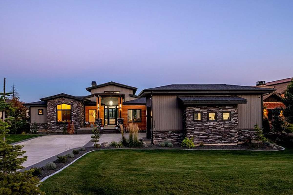 Modern house plan exterior with stone and wood facade, prominent entry, large windows, and multiple gables.
