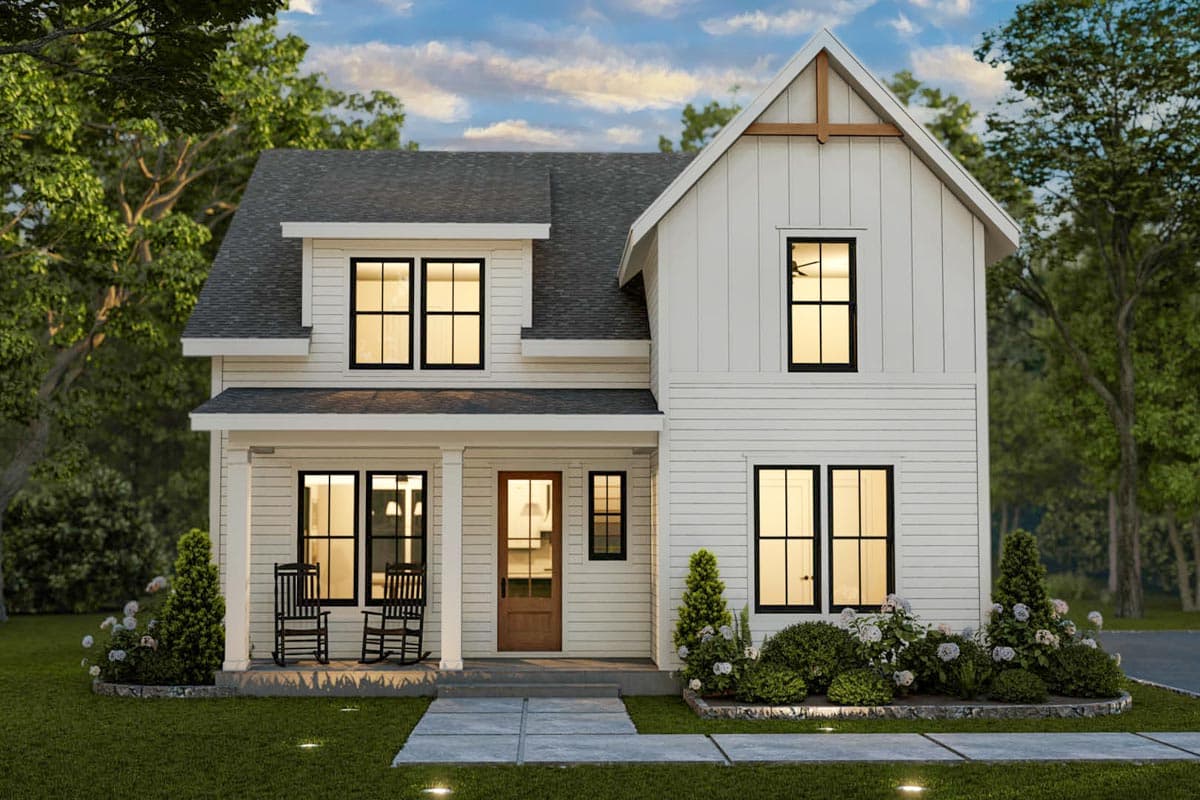 Two-story Modern Farmhouse exterior with a front porch, gables, and vertical siding. Black framed windows and a wood front door.