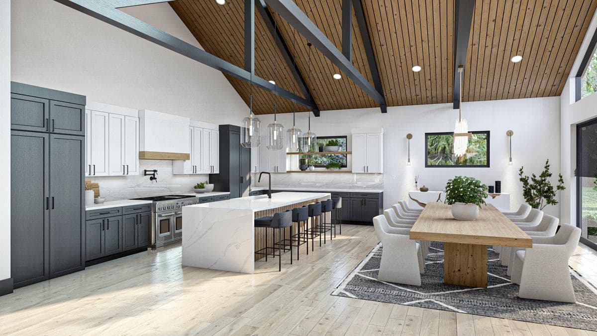 Modern open-plan kitchen and dining area featuring a large island with bar stools, a long dining table, and high vaulted wooden ceiling.