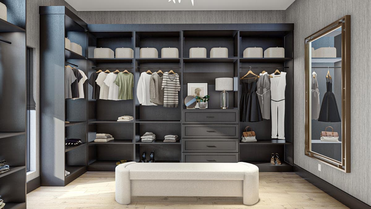 A luxurious walk-in closet with dark built-in shelving, organized clothing, a white bench, and a full-length mirror reflecting the space.
