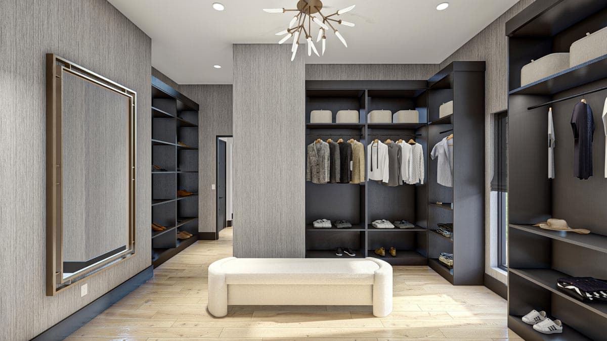 Spacious walk-in closet with dark shelving, clothes, and a neutral-colored bench. A large mirror and decorative lighting add luxury to the space.