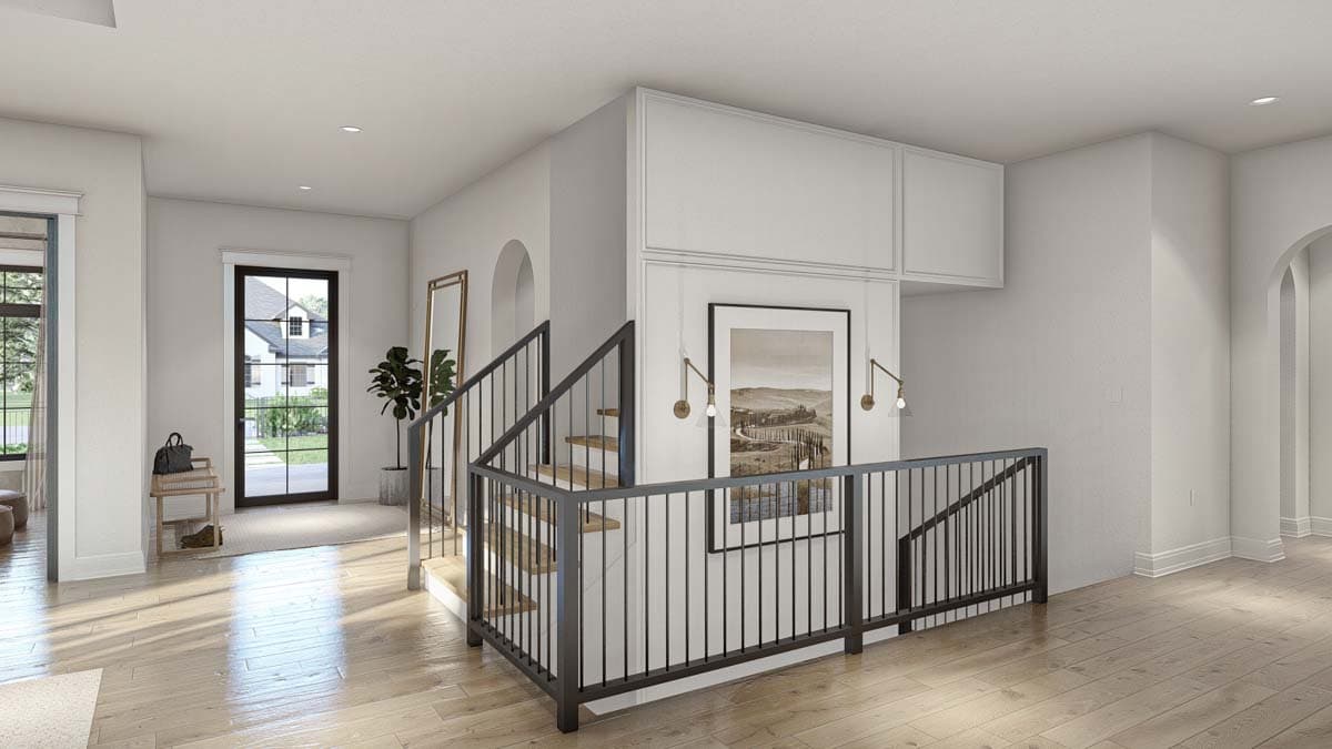Interior view of a contemporary house landing with a staircase featuring metal railings, a large framed artwork, and natural light.