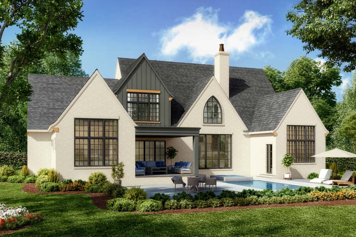 House plan exterior with white brick facade, dark-framed windows, gabled rooflines, covered patio, and pool.