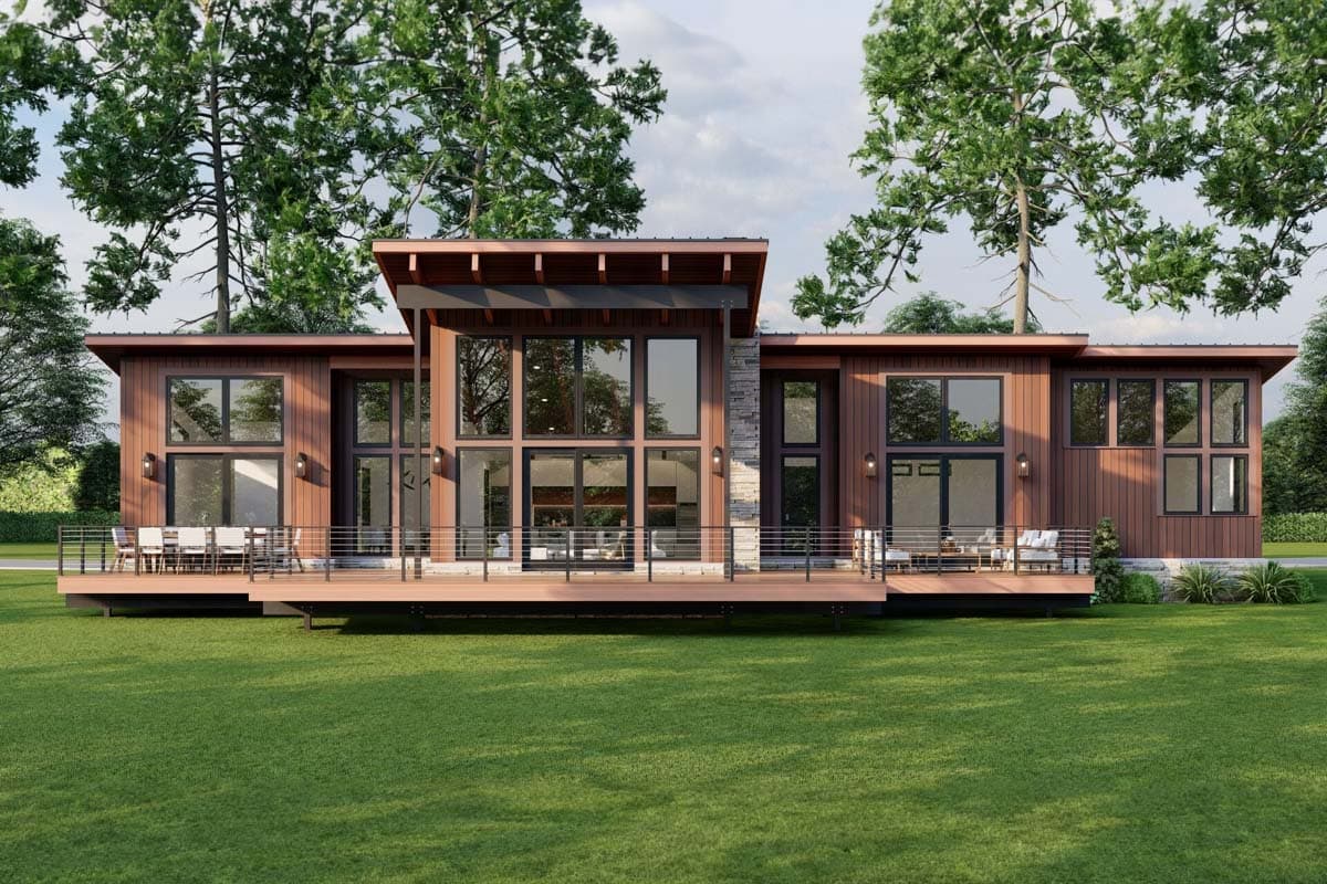 Modern house plan exterior with a large wraparound deck, expansive glass walls, and a low-pitched roof.