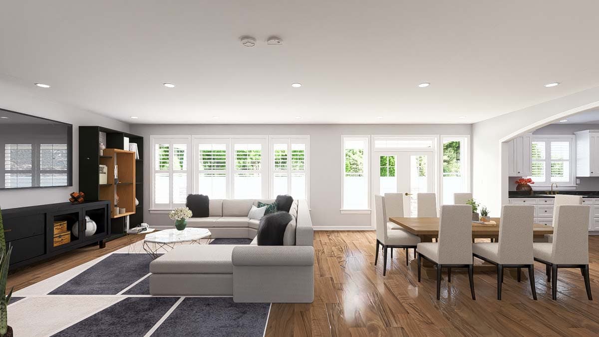 Open-concept living and dining area with sectional sofa, dining table, and adjacent kitchen.