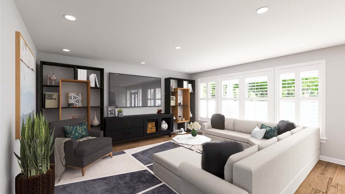 Living room with sectional sofa, entertainment center, bookshelves, and large windows with shutters.