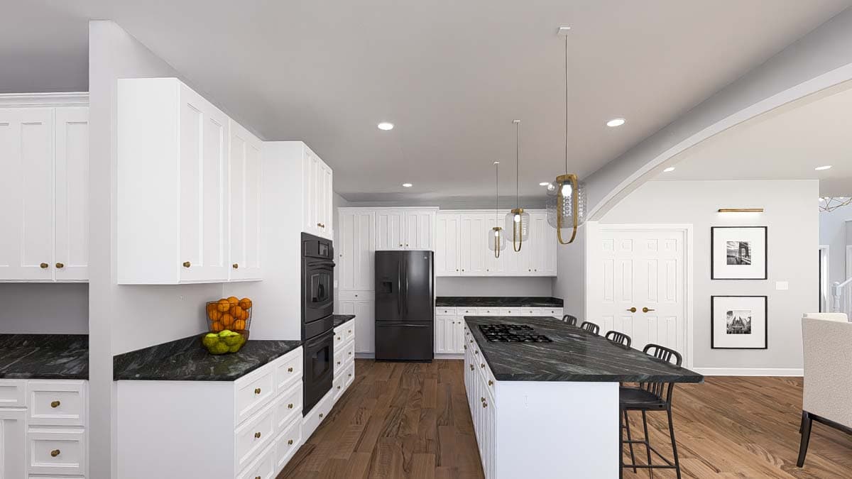 Kitchen with white shaker cabinets, large island with gas cooktop, black appliances, and dark granite countertops.