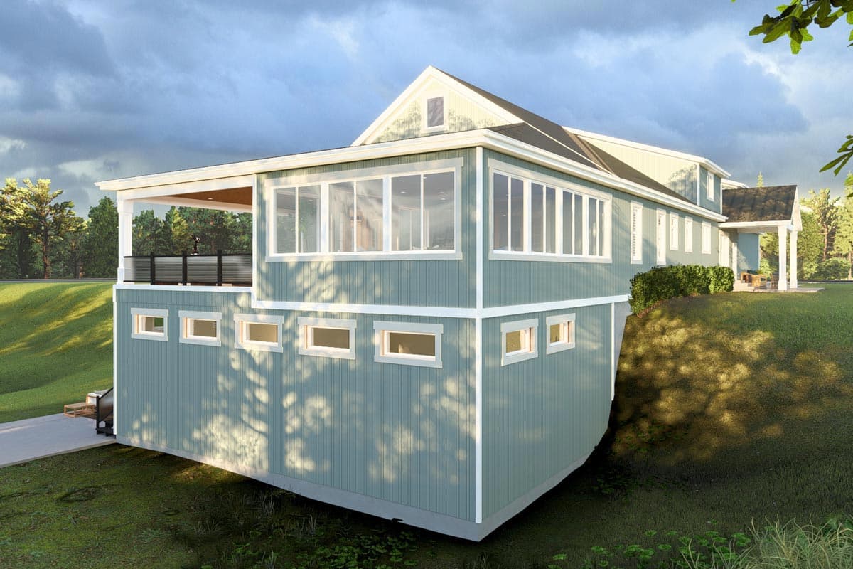House plan exterior with covered deck, two levels of siding, and numerous rectangular windows. Gable dormer on upper roof.