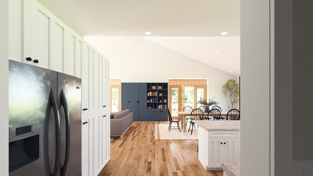 Open concept great room with vaulted ceiling, fireplace, and natural light. Kitchen island and dining area visible.