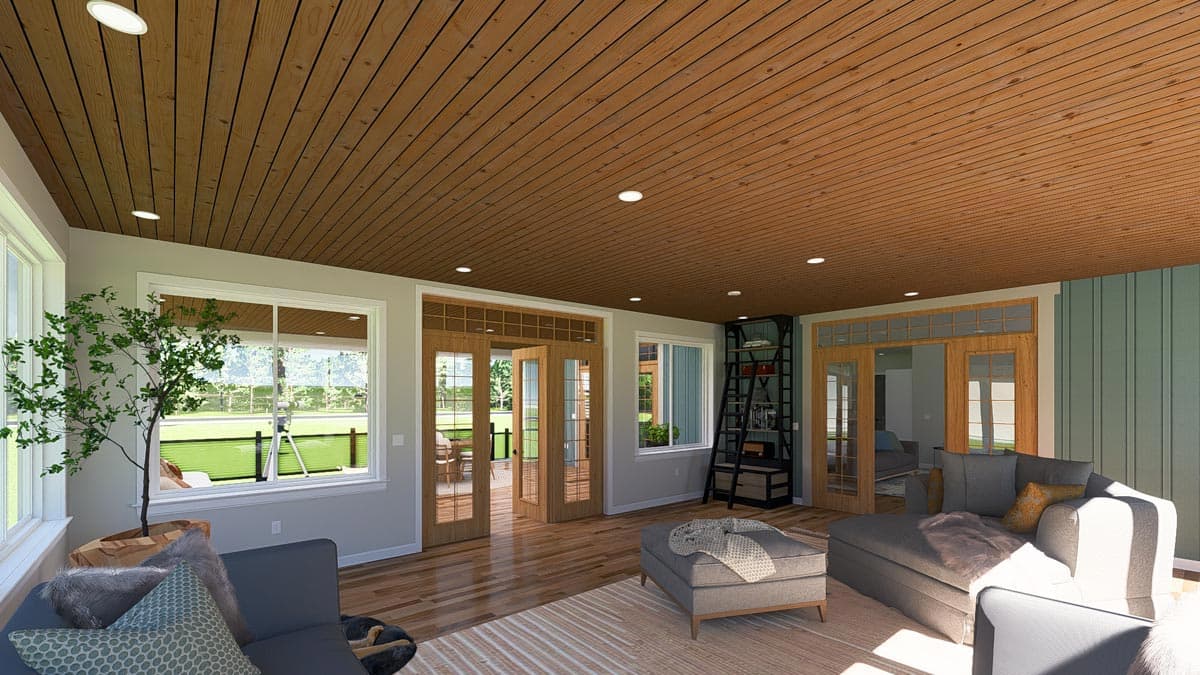 Sunroom interior with wood plank ceiling, large windows, French doors, and seating area.