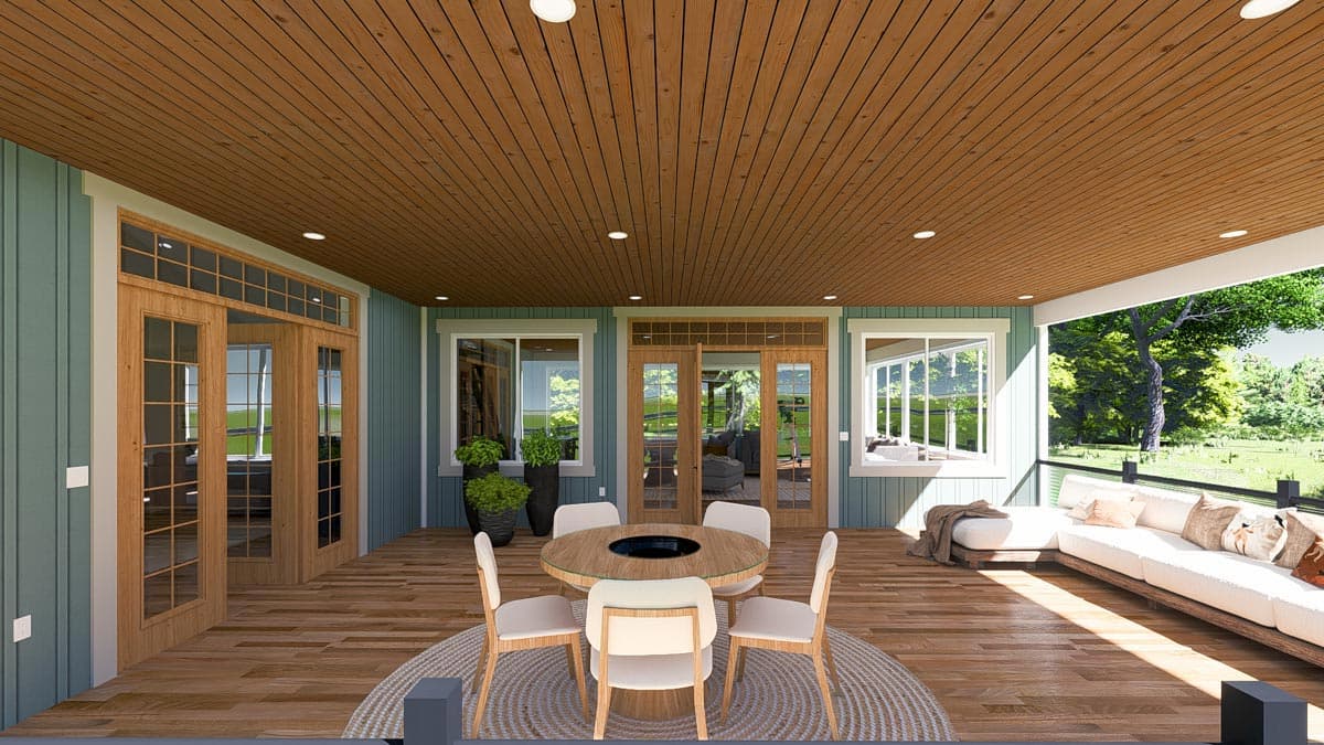 Covered porch with wood ceiling, dining set, sectional sofa, and French doors leading inside. House plan exterior.